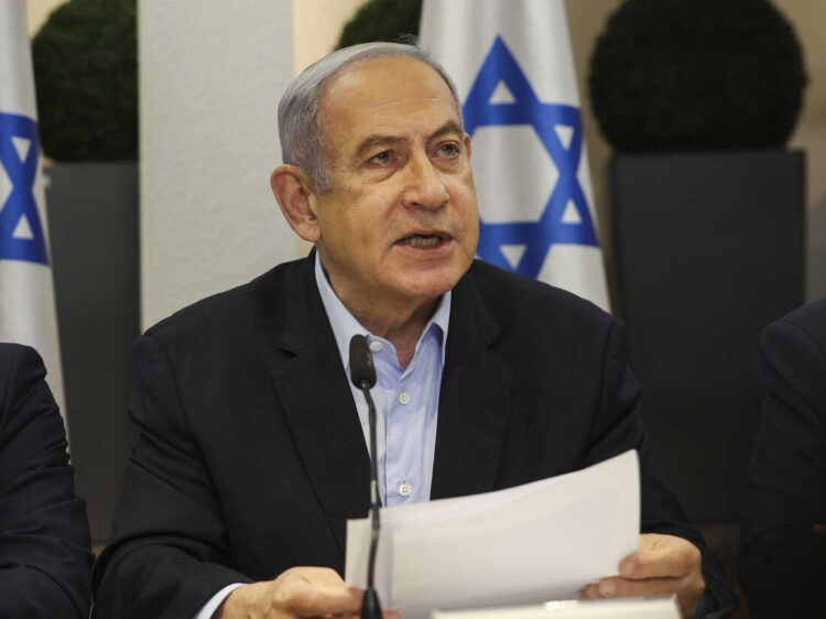 Israeli Prime Minister Benjamin Netanyahu, centre, speaks during the weekly cabinet meeting at the Defence Ministry in Tel Aviv, Israel, Sunday Jan. 7, 2024. (Ronen Zvulun/Pool via AP)