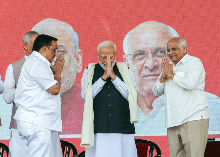 Ahmedabad, Feb 22 (ANI): Prime Minister Narendra Modi greets during the Golden Jubilee celebrations of the Gujarat Cooperative Milk Marketing Federation, at Narendra Modi Stadium, in Ahmedabad on Thursday. Gujarat Chief Minister Bhupendra Patel and Bharatiya Janata Party (BJP) State Chief CR Patil are also present. (ANI Photo)