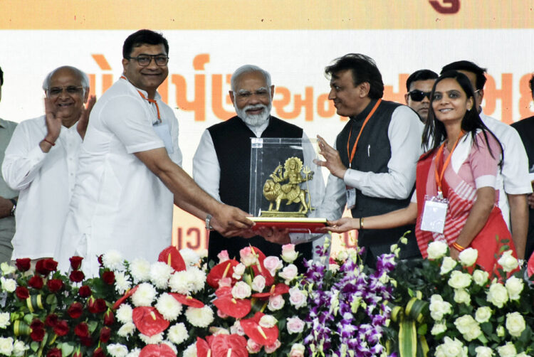 Navsari, Feb 23 (ANI): Prime Minister Narendra Modi being felicitated at the foundation stone-laying ceremony of multiple development projects, in Navsari on Thursday. Gujarat Chief Minister Bhupendra Patel is also present. (ANI Photo)