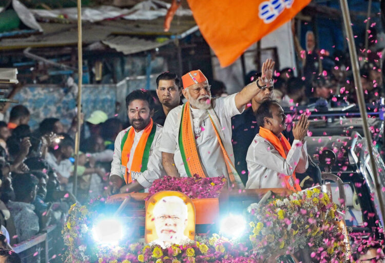 Hyderabad, Mar 15 : Prime Minister Narendra Modi greets the gathering during a road show in Malkajgiri Parliamentary constituency ahead of the Lok Sabha elections, in Hyderabad on Friday. Telangana BJP President and Union Minister G.Kishan Reddy and Etala Rajender BJP candidate for Malkajgiri Parliamentary constituency also present.