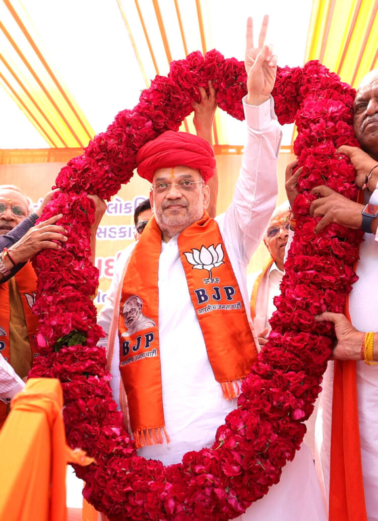 Gandhinagar, Mar 15: Union Home Minister Amit Shah being garlanded by BJP supporters during a public meeting for the upcoming Lok Sabha elections, in Gandhinagar on Friday.