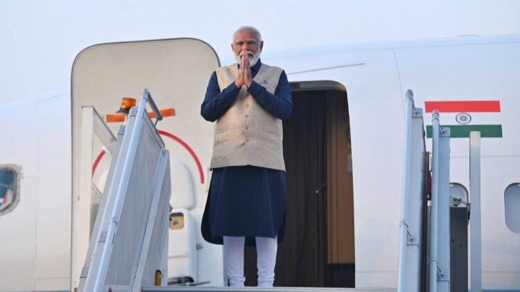 Prime Minister Narendra Modi greets before departing for a two-day visit to Bhutan, in New Delhi, Friday, March 22, 2024