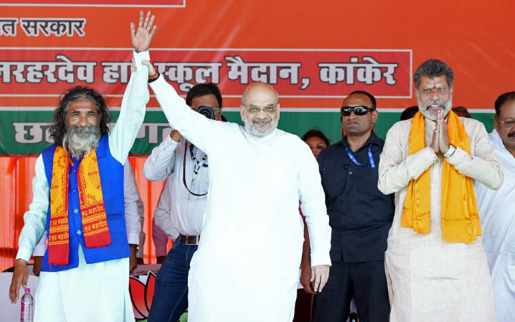 Kanker, Apr 22: Union Home Minister Amit Shah and Bharatiya Janata Party (BJP) candidate from Kanker constituency Bhojraj Nag during a public meeting for the Lok Sabha polls, in Kanker on Monday.