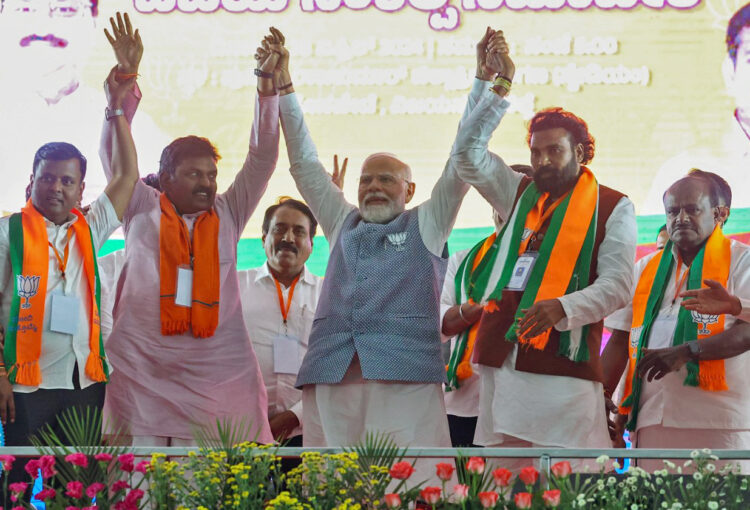 Ballari, Apr 28: Prime Minister Narendra Modi holds hands with Bharatiya Janata Party (BJP) candidate from Ballari rural seat B Sriramulu and others at a public meeting for the third phase of the Lok Sabha elections, in Ballari on Sunday.