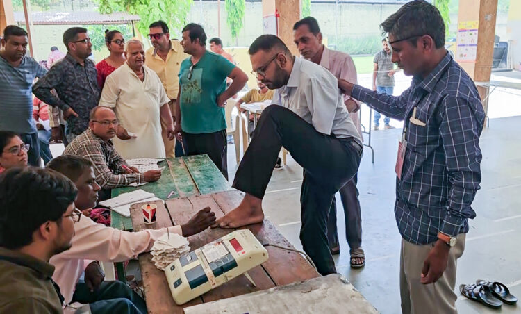 Nadiad, May 7: A specially-abled voter Ankit Soni gets his feet marked with indelible ink before casting his vote for the third phase of the Lok Sabha polls, at a polling booth, in Nadiad on Tuesday.