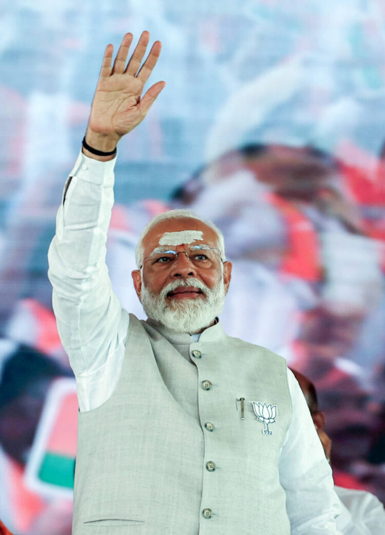 Prime Minister Narendra Modi greets the supporters during a public meeting in support of the Bharatiya Janata Party (BJP) candidate from Karimnagar seat Bandi Sanjay Kumar for the Lok Sabha polls, in Karimnaga