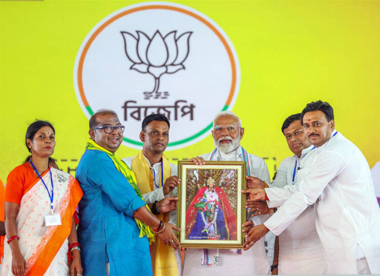 Jhargram, May 20: Prime Minister Narendra Modi being felicitated by Bharatiya Janata Party (BJP) candidate from Jhargram seat Pranat Tudu, West Bengal party chief Sukanta Majumdar and others during a public meeting for the Lok Sabha elections, in Jhargram on Monday.