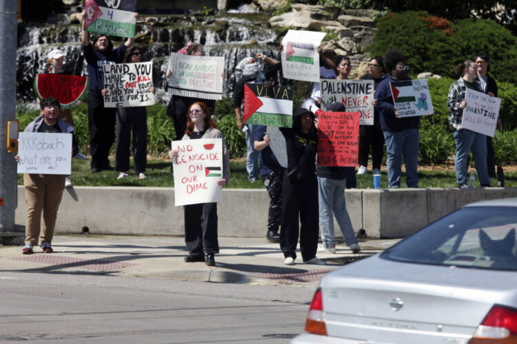 About 40 students at Washburn University stage a protest expressing support for Palestinians in Gaza and calling for a cease fire in the war there, Friday, May 3, 2024, in Topeka, Kan. The students are critical of Israel's military operations and U.S. President Joe Biden's support for Israel. (AP Photo/John Hanna)