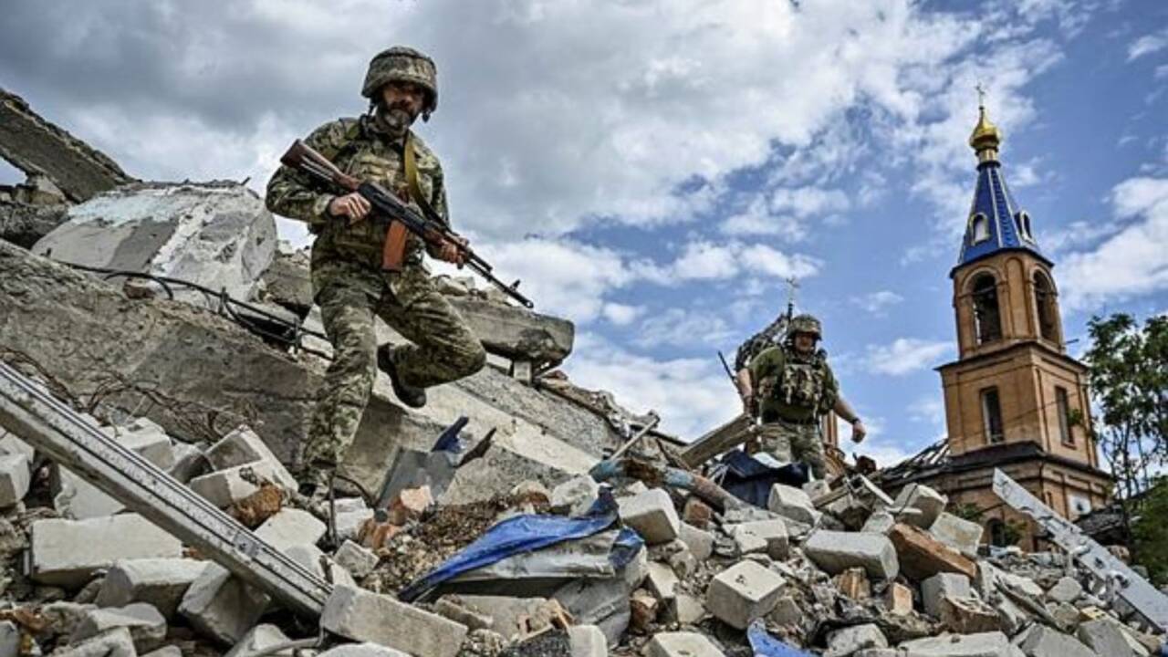 Ukrainian servicemen patrol an area heavily damaged by Russian military strikes (REUTERS)