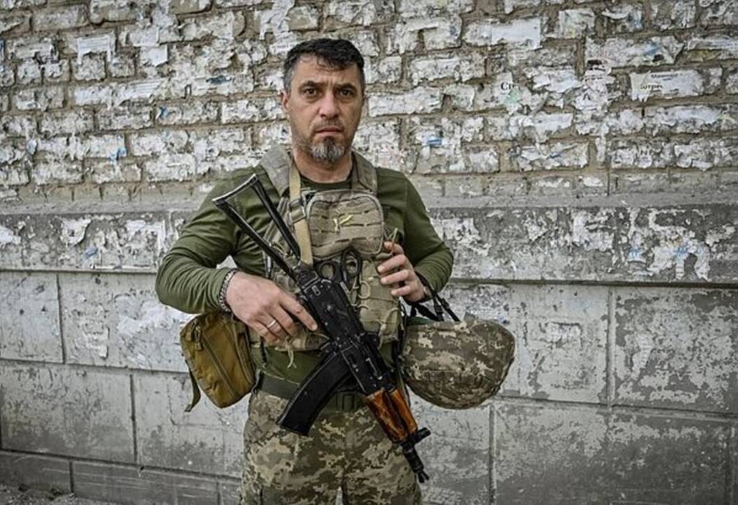 A Ukrainian serviceman poses for a photo in the town of Orikhiv, which has been heavily damaged by Russian military strikes amid the ongoing conflict in Ukraine. (Image- Reuters)