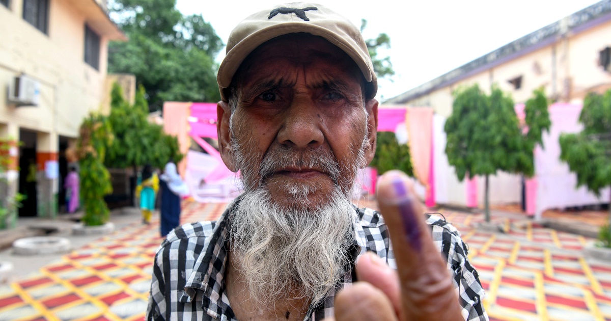 An elderly voter shows his ink-marked finger after casting his vote for the fourth phase of the Lok Sabha polls, at a polling station, in Etawah on Monday. (ANI Photo)