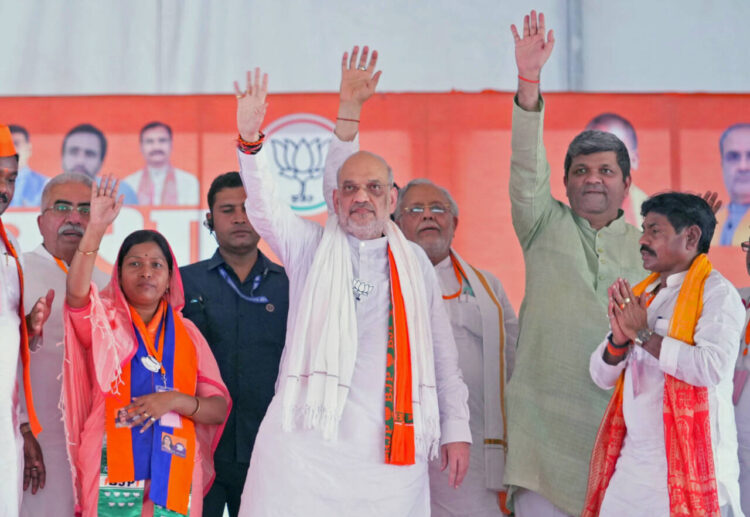 Robertsganj, May 29: Union Home Minister Amit Shah greets people during a public meeting for the last phase of Lok Sabha polls, in Robertsganj on Wednesday.