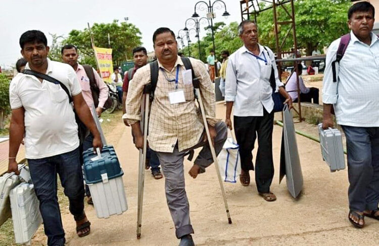 Deoghar, May 31: A specially-abled polling official along with other officials leave for their respective polling booths after collecting EVMs and other election materials on the eve of the last phase of the Lok Sabha polls, in Deoghar on Friday.