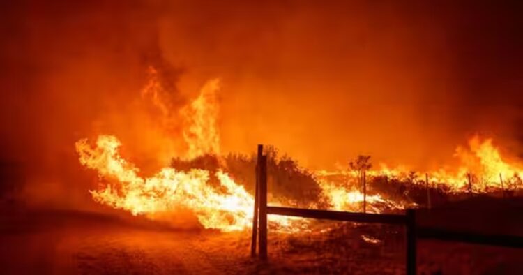 Strong winds pushed flames through dry brush in mountains along Interstate 5 north of Los Angeles and officials warned residents in the wildfire’s path to be prepared to leave if it explodes in size again.