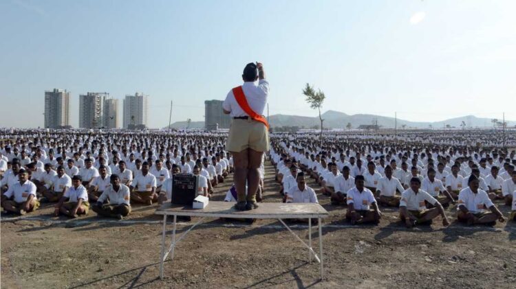 Members of the Rashtriya Swayamsevak Sangh, or RSS, stand at attention and salute a saffron-orange flag at a morning shakha, or drill session, in a park in suburban Mumbai, India.

(Lauren Frayer/NPR)